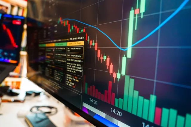 Close-up of a financial monitor displaying real-time cryptocurrency data and charts in a modern office. Seven checks for UK buyers of AI marketing analytics tools