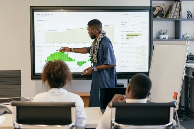 Engaging business presentation featuring data analysis on a large monitor. How AI marketing tools' attribution methods differ